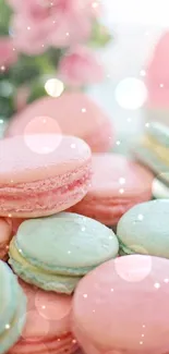 Pastel pink and blue macarons on a decorative plate with floral accents.