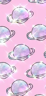 Pastel planets with glitter on a pink background wallpaper.