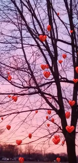 Pastel pink sunset with tree silhouettes.