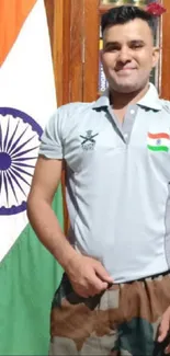 Proud Indian soldier standing with flag in library backdrop.