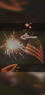 Person holding sparkler with American flag in background.