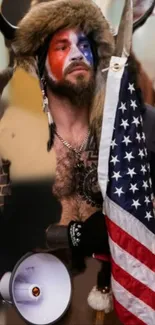 Bearded man in tribal attire with face paint and American flag.