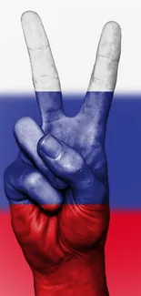 Peace sign hand in Russian flag colors on wallpaper.