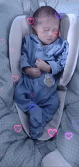 Sleeping baby in blue outfit on cozy bedding.