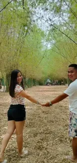 Couple holding hands in a bamboo forest pathway.