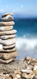 Stack of stones on a beach with ocean backdrop.