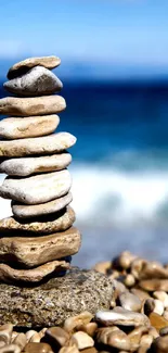 Stacked beach stones with ocean background.