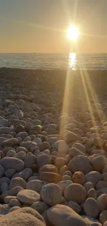 Calming beach sunset with pebbles and golden light.