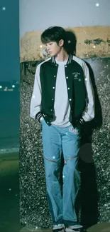 A serene beachside photo with a person leaning on a pillar at night.