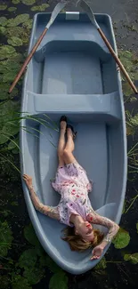 Woman relaxing on a blue-grey boat, surrounded by peaceful water lilies.