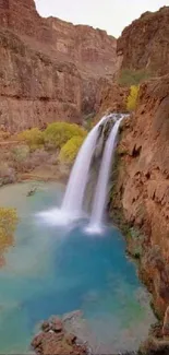 A calming waterfall flowing through a picturesque canyon landscape.