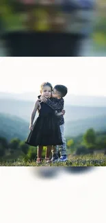 Two children hugging in a serene green valley.