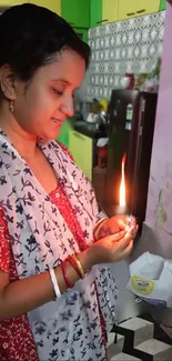 Woman lighting a candle in a colorful kitchen.