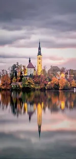 Island church reflected in a calm lake with misty clouds.