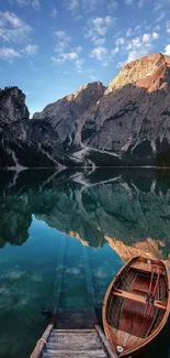 A serene mountain lake with trees and clouds reflecting in calm waters.