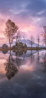 Serene sunset over a lake with tree reflections and distant mountains.