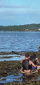 Two kayakers enjoying a peaceful lake adventure under a clear blue sky.