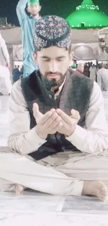 Man meditating at spiritual shrine in peaceful evening setting.