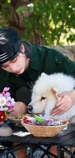 Person and fluffy dog enjoying an outdoor picnic.