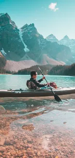 Person kayaking on a serene mountain lake with a stunning backdrop.