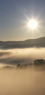 Sunrise over misty mountains with soft light and serene sky.