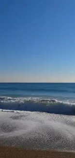 A serene wallpaper of ocean waves under a clear blue sky, perfect for calming your device.