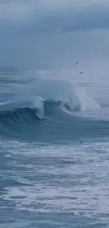 Serene ocean wave with cloudy sky, perfect for mobile wallpaper.