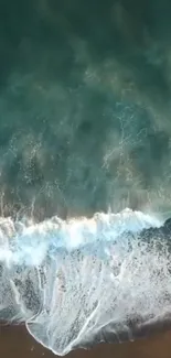 Aerial view of calming ocean waves crashing on the beach shore.