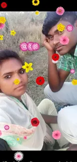 Couple sitting outdoors with grassy background.