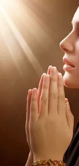 Serene silhouette in prayer with golden light background