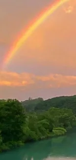 Colorful rainbow over a lush forest and serene river.