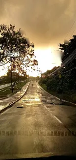 Serene road view with rain under a golden sunset sky.