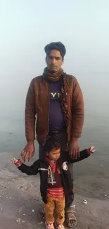 A father and child at a serene riverbank.