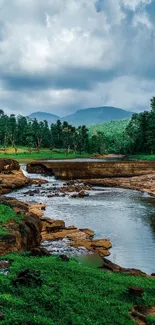 Scenic river landscape with green trees and a cloudy sky.