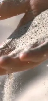 Serene close-up of sand flowing through a hand.