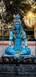 Blue Shiva statue in peaceful meditation.