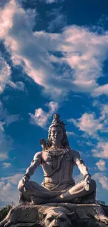 Serene Shiva statue with clouded blue sky backdrop.