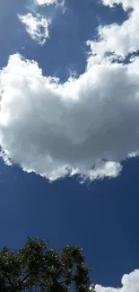 Sky with fluffy clouds against a vibrant blue background on a sunny day.