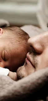 Father and baby peacefully sleeping on cozy blanket.