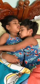 Two children sleeping peacefully in matching blue outfits on a cozy bed.