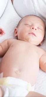 A peaceful sleeping baby on a soft, white blanket, creating a serene ambiance.