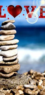 Stacked stones on a beach with 'Love' on blue ocean backdrop.