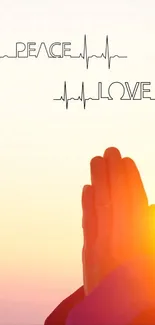 Hands in prayer with 'Peace Love' text above a sunrise.