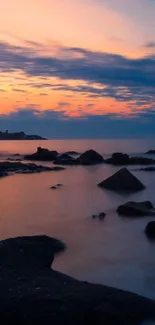 Serene sunset beach scene with vibrant sky and calm waters.