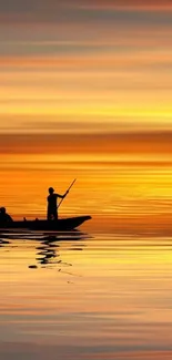 Silhouette of a boat at sunset with orange reflections on water.