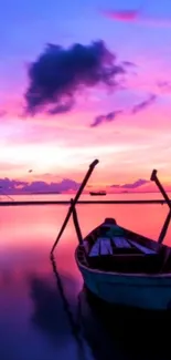 Sunset boat on calm waters with pink and purple skies.