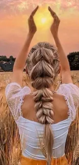 Woman in wheat field during a golden sunset, embracing serenity.