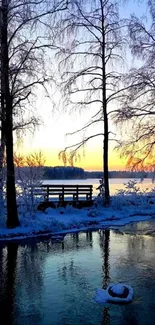 Serene winter sunset over frozen lake with frosty trees.