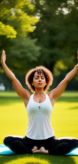 Person doing yoga on a mat in a lush green park.