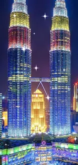 Petronas Towers illuminated at night in Kuala Lumpur cityscape.